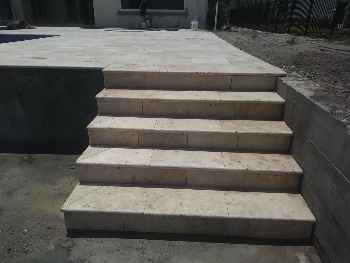 Travertine steps up to a raised patio
