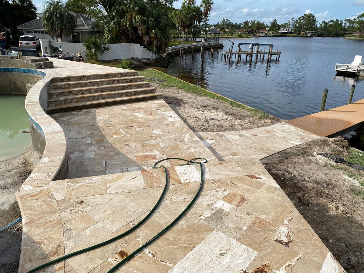 Curved paver steps and seat wall by the water