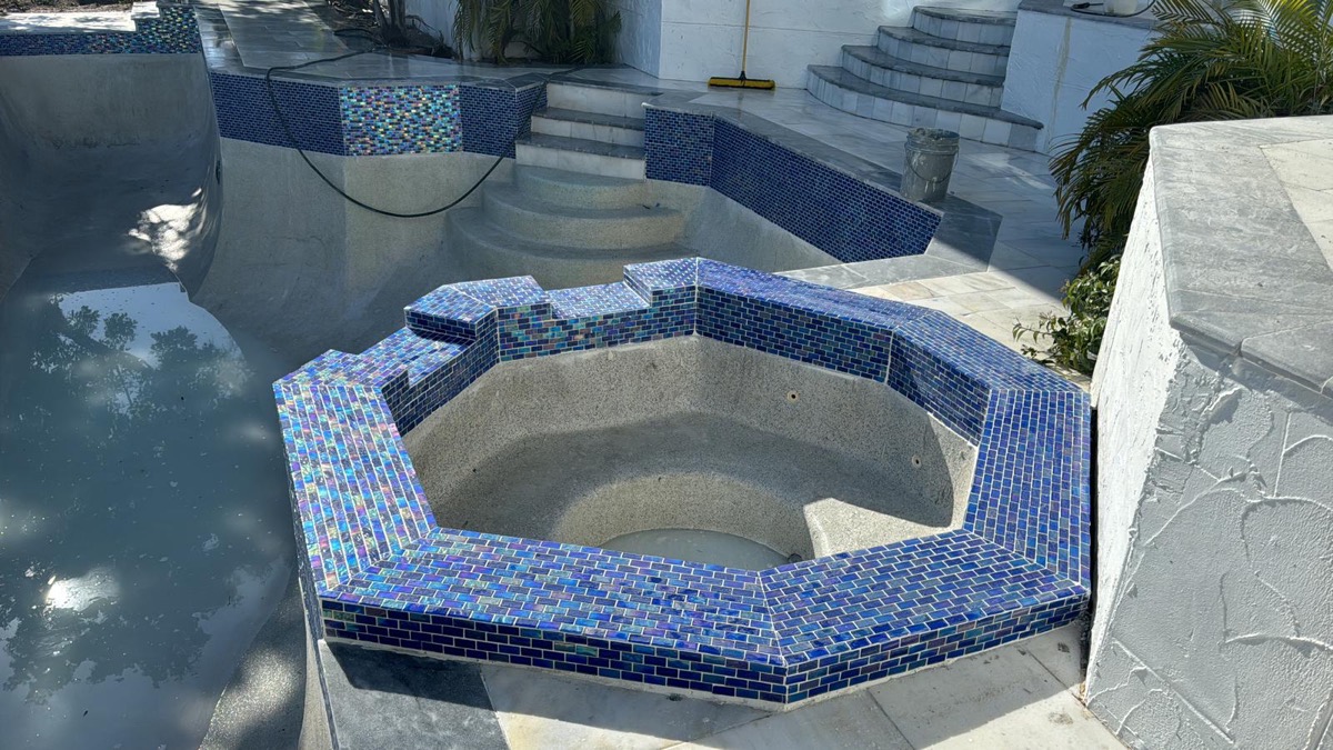 Octagonal spa with blue glass mosaic tile